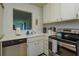 Cozy kitchen with white cabinets, a stainless steel dishwasher and oven at 476 Zelda Blvd, Daytona Beach, FL 32118