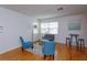 Living room features hardwood floors, two blue chairs, a loveseat and bright windows at 476 Zelda Blvd, Daytona Beach, FL 32118
