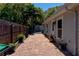 Home exterior with a brick pathway, privacy fence, and tropical landscaping at 5108 Sunrise Blvd, Orlando, FL 32803