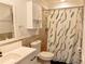 Bright bathroom features a single vanity, toilet, mirror and shower at 5108 Sunrise Blvd, Orlando, FL 32803