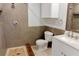 A modern bathroom features a tiled shower, cabinet storage and stone counters at 5108 Sunrise Blvd, Orlando, FL 32803