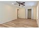 Bedroom with light wood floors, closet and adjacent room offers ample space at 5108 Sunrise Blvd, Orlando, FL 32803