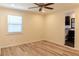 Bedroom with light wood floors, ceiling fan, and a window for natural light at 5108 Sunrise Blvd, Orlando, FL 32803