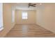 Bedroom features light wood floors, ceiling fan, and ample light at 5108 Sunrise Blvd, Orlando, FL 32803