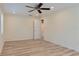 Spacious bedroom with light hardwood floors, ceiling fan and neutral walls with a walk-in closet at 5108 Sunrise Blvd, Orlando, FL 32803