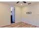 Bedroom featuring light wood floors, ceiling fan, and a wall-mounted TV bracket at 5108 Sunrise Blvd, Orlando, FL 32803
