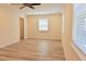 Bright bedroom featuring wood floors, neutral walls, two windows, and an open closet at 5108 Sunrise Blvd, Orlando, FL 32803