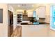 Bright kitchen featuring stainless steel appliances, bar seating, and wood look floors at 5108 Sunrise Blvd, Orlando, FL 32803