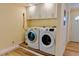 Bright laundry room with wood-look floors and washer and dryer hookups at 5108 Sunrise Blvd, Orlando, FL 32803