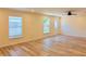 Well-lit living room with wood look floors featuring large windows at 5108 Sunrise Blvd, Orlando, FL 32803