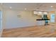 Open concept living room with kitchen, stainless steel appliances, and hardwood floors at 5108 Sunrise Blvd, Orlando, FL 32803