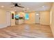 Large living room with wood floors leading to kitchen and front entrance at 5108 Sunrise Blvd, Orlando, FL 32803