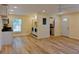 Open concept living space with laundry, kitchen, entrance and hardwood floors at 5108 Sunrise Blvd, Orlando, FL 32803