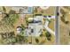 Aerial view showing a large lot with a pool and a screened in lanai and mature landscaping at 5170 Ne 64Th Ave, Silver Springs, FL 34488