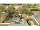 Aerial view of backyard oasis featuring a screened pool, solar panels, lush lawn, and mature trees at 5170 Ne 64Th Ave, Silver Springs, FL 34488