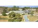 Landscaped yard with palm trees and a long driveway lead to this charming home with a three car garage at 5170 Ne 64Th Ave, Silver Springs, FL 34488