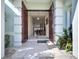 Grand entrance with decorative columns, marble floors, and custom wood double doors at 5170 Ne 64Th Ave, Silver Springs, FL 34488