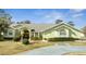 Charming single-story home with lush landscaping, well-manicured lawn, and large arched window at 5170 Ne 64Th Ave, Silver Springs, FL 34488