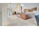 Hallway view to the kitchen featuring travertine floors and light yellow walls at 5170 Ne 64Th Ave, Silver Springs, FL 34488