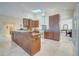 Kitchen with a central island, skylight, and wood cabinets at 5170 Ne 64Th Ave, Silver Springs, FL 34488