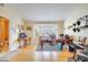 Spacious living room with light hardwood floors, a bright bay window, and plenty of space for various activities at 5170 Ne 64Th Ave, Silver Springs, FL 34488