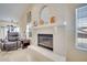 Bright living room boasts a fireplace, white painted brick, and neutral wall colors at 5170 Ne 64Th Ave, Silver Springs, FL 34488