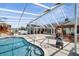 A screened-in pool sits near an outdoor kitchen and gazebo, offering a luxurious outdoor space for the property at 5170 Ne 64Th Ave, Silver Springs, FL 34488