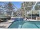 Screened in pool and spa surrounded by tropical greenery for a private oasis at 5170 Ne 64Th Ave, Silver Springs, FL 34488