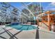 Screened-in pool with attached spa and outdoor bar and grill perfect for outdoor entertaining at 5170 Ne 64Th Ave, Silver Springs, FL 34488
