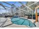 A screened-in pool and integrated hot tub offer a relaxing oasis in the Florida sunshine at 5170 Ne 64Th Ave, Silver Springs, FL 34488