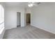 Neutral bedroom features a ceiling fan, a large window and a closet for ample storage space at 6612 S Goldenrod Rd # 104A, Orlando, FL 32822