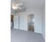 Bedroom featuring a ceiling fan, light gray walls, and an attached bathroom at 6612 S Goldenrod Rd # 104A, Orlando, FL 32822