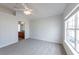This bedroom features a large window, carpet floors, and an adjacent bathroom for convenience at 6612 S Goldenrod Rd # 104A, Orlando, FL 32822