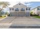 Well maintained exterior with grey garage doors, neutral paint, and second story balconies at 6612 S Goldenrod Rd # 104A, Orlando, FL 32822