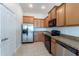 Efficient kitchen design with stainless steel refrigerator, black appliances, and tile flooring at 6612 S Goldenrod Rd # 104A, Orlando, FL 32822