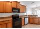 Cozy kitchen with wooden cabinets, neutral countertops, and modern appliances at 6612 S Goldenrod Rd # 104A, Orlando, FL 32822
