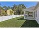 Backyard featuring a covered patio, white fence and lush green lawn at 8007 Colby Cir, Orlando, FL 32817
