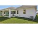 Backyard featuring a covered patio and lush green lawn at 8007 Colby Cir, Orlando, FL 32817