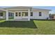 Backyard featuring a covered patio and lush green lawn at 8007 Colby Cir, Orlando, FL 32817