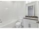 Bright bathroom featuring a tile tub, vanity, and modern fixtures at 8007 Colby Cir, Orlando, FL 32817