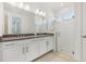 Bright bathroom with double sink vanity, granite countertop, and glass shower with white tile at 8007 Colby Cir, Orlando, FL 32817