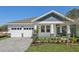 Beautiful one-story home with an attached two-car garage and a cozy, covered entryway with stone-accented columns at 8007 Colby Cir, Orlando, FL 32817