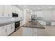 Modern kitchen featuring white cabinets, stainless steel appliances, a spacious island and stylish countertops at 8007 Colby Cir, Orlando, FL 32817