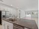 Bright kitchen featuring a gray countertop island and stainless steel appliances at 8007 Colby Cir, Orlando, FL 32817