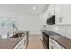 Bright modern kitchen featuring stainless steel appliances, stylish countertops, a kitchen island, and white cabinetry at 8007 Colby Cir, Orlando, FL 32817