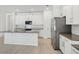 Modern kitchen featuring white cabinets, stainless steel appliances, a spacious island and stylish countertops at 8007 Colby Cir, Orlando, FL 32817