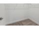 Spacious walk-in closet featuring neutral carpet and white walls and trim at 8007 Colby Cir, Orlando, FL 32817