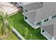 Aerial view of a grassy backyard with white fencing and a covered patio at 8013 Colby Cir, Orlando, FL 32817