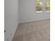 Bedroom featuring neutral carpet, baseboard trim, and a window for natural light at 8013 Colby Cir, Orlando, FL 32817