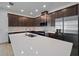 Modern kitchen features a large island, dark cabinets, and stainless steel appliances at 8013 Colby Cir, Orlando, FL 32817